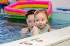 Practicing the "monkey walk" during an infant and toddler swim class.